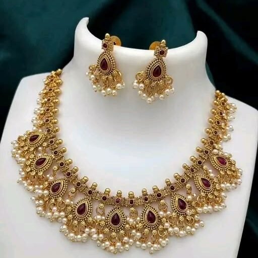 A stunning round necklace set featuring vibrant red stones